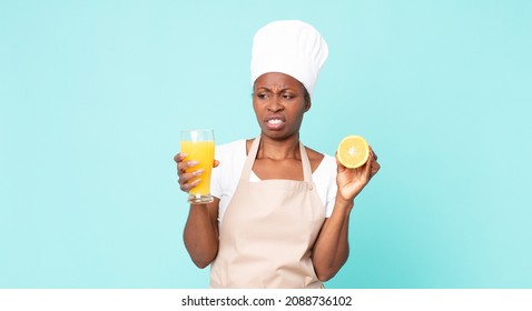 Black African American Adult Chef Woman . Orange Juice Concept