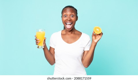 Black African American Adult Woman. Orange Juice Concept