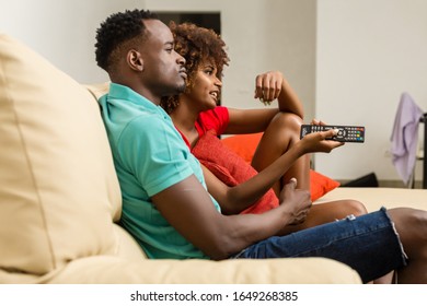 Black African American Couple Watching Tv In The Living Room