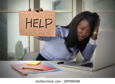 black African American ethnicity tired and frustrated woman working as secretary in stress at work business district office desk with computer laptop asking for help in frustration concept