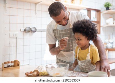 Black African American Father Enjoy Playing With Little Son While Baking Cake Or Cookie In The Kitchen, Family Have Fun Cooking