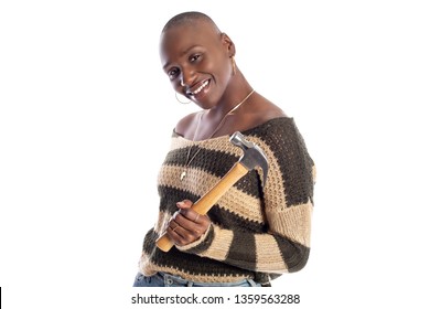 Black African American Female Model Holding A Hammer Repair Tool Looking Independent And Self Reliant.  She Is Depicting Home Improvement And Woman Individualism. 