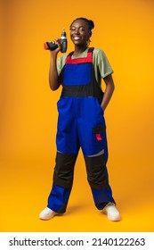 Black African American Female Model In Uniform Holding A Screwdriver Repair Tool Against Yellow Background