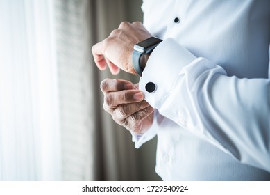 Black African American Man Getting Ready For Wedding Or Fancy Event By Buttoning Cuff Links