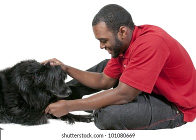 Black African American Man Playing With A Dog