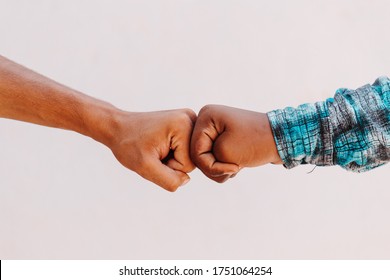 Black African American race male and white Caucasian woman hands giving a fist bump in agreement partnership and cooperation multiracial diversity and immigration concept. Stop racism concept