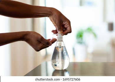 Black African American Woman Hand Using Antibacterial Antiseptic Hand Sanitizer Gel