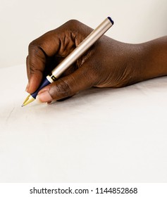 Black African Female(woman) Hand Holding A Pen Isolated White Surface, With Arm Writing. 