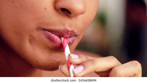Black african girl mouth drinking smoothie with straw