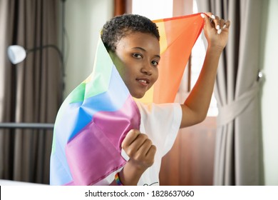 Black African LGBT Woman Holding LGBTQ Rainbow Flag, Lesbian Pride Or LGBT Pride Movement, Inclusivity, Diversity Of People Concept