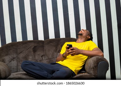 black african male hipster chatting with Friends on social network using mobile device