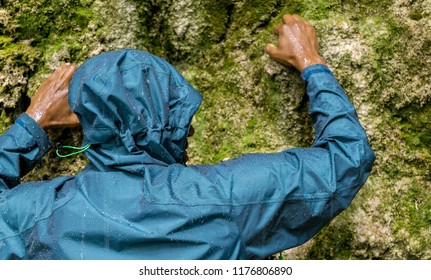 Black African Man Climbing Wet Rock Wall In Rain. Allgau, Bavaria, Germany