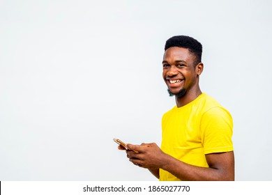 Black African Millennial Chatting With Friends On Social Media, Reading Online News. Young University Student Paying Bills With Mobile Phone