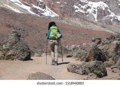 Black African Woman Walking Up Mount Kilimanjaro In Tanzania