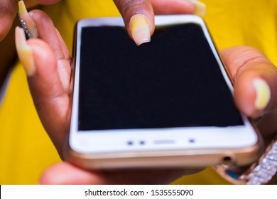 Black African women using a touchscreen display phone chatting with friends on social media - Shutterstock ID 1535555090