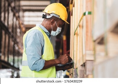 Black African worker wear protective face mask and helmet check stock in warehouse. Concept of new normal work in industry, factory after Covid 19 pandemic - Shutterstock ID 1763430239