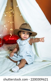 Black, African-american Girl Play In A Tent, Wigwam. Kid In A Hat Showing A Finger. Happy Childhood