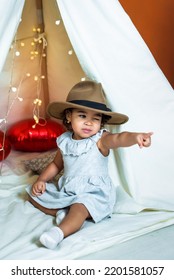 Black, African-american Girl Play In A Tent, Wigwam. Kid In A Hat Showing A Finger. Happy Childhood