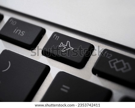 Black airplane mode or  flight mode on a laptop keyboard closeup