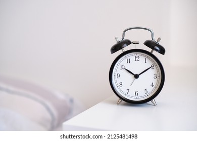 Black Alarm Clock On Night Stand, Ten Past Ten Oclock