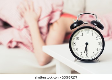 Black Alarm Clock And Woman