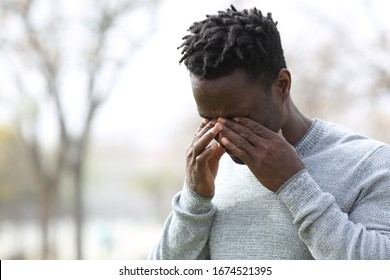 Black Allergic Man Scratching Itchy Eyes Standing In A Park In Winter