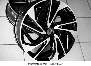 Black alloy wheels on a car, close-up. Purchase and replacement of autodisks.