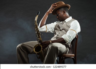 Black american jazz saxophone player. Vintage. Studio shot.
