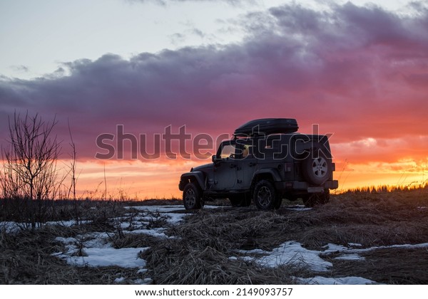 Black American Jeep Wrangler SUV on the\
background of a beautiful sunset\
03222022