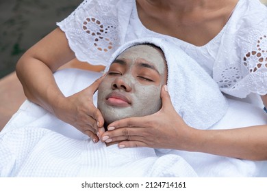 Black American Woman Uses A Facial Mask And Has A Massage Therapist Relax In The Spa Salon. Wellness, Beautiful Health And Relax Concept