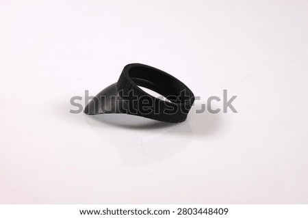 Black angled microscope eyecup isolated on a white background. Replacement rubber accessory for microscope eyepieces, providing comfortable viewing and improved light shielding.