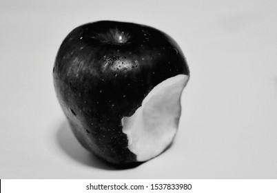 Black Apples Have A Bite Mark On The Floor.