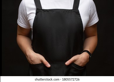 Black Apron On A Man Closeup. Hands In Pockets. Place For Text. Copy-space.