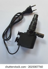 Black Aquarium Submersible Pump On White Background. Pump For Water Circulation And Wave Maker. Fish Aquaculture Tank And Water System. Malaysia 2 Pins Socket Plug