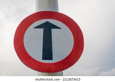 A Black Arrow Traffic Symbol On A White Background To Go Straight.