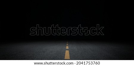 Black asphalt road and empty dark street scene background with studio room interior texture for display products wall background.	