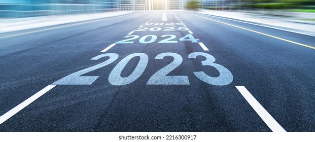 Black asphalt road with new year numbers 2023, 2024 to 2026 with white dividing lines - Shutterstock ID 2216300917
