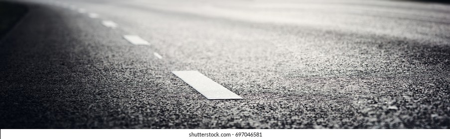 black asphalt road and white dividing lines - Powered by Shutterstock