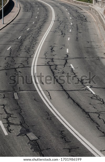 Black asphalt road and white dividing lines.\
Highway traffic road. Road\
patches.