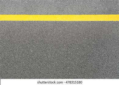 Black asphalt tarmac road or street and yellow line on top view texture background