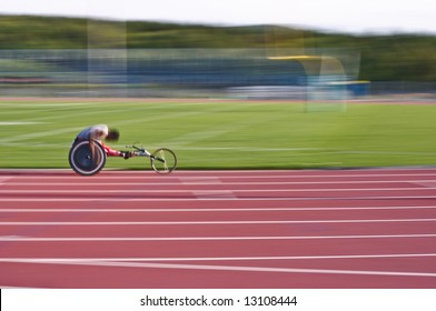 Black Athlete Racing In A Wheelchair On A Track