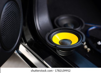 The Black Audio Loudspeaker With Yellow Diaphragm. Car Audio Installation Concept.