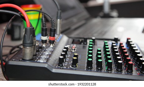 Black audio mixing controller board console close up in perspective, entertainment DJ equipment electronics
