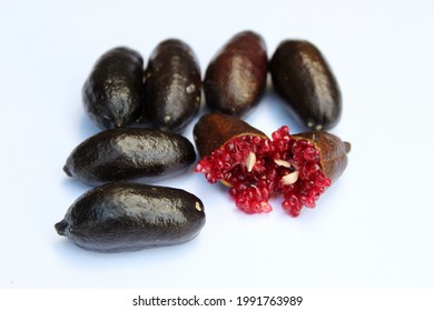 Black Australian Native Finger Lime Showing Ruby Red Fruit Caviar Flesh And Seeds. This Citrus Variety Has Black Skin.