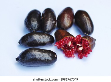 Black Australian Native Finger Lime Showing Ruby Red Fruit Caviar Flesh And Seeds. This Citrus Variety Has Black Skin.