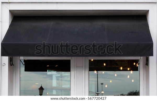 black awning over cafe\
windows