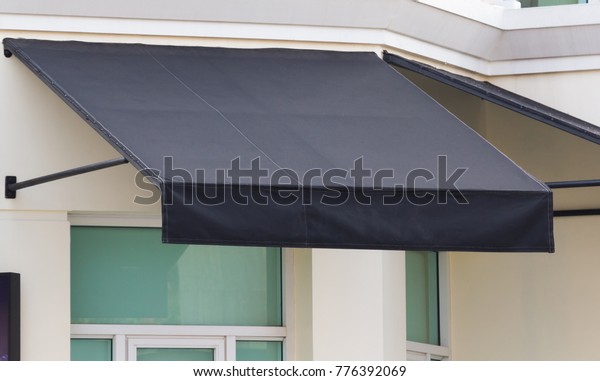 black awning and steel structure over window\
frame, outdoor house\
decoration