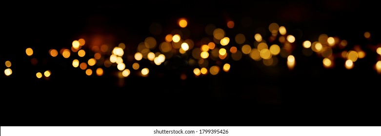 Black background with golden light effects. Horizontal background with blur bokeh effects for christmas time. Special occasion concept with space for text. - Shutterstock ID 1799395426