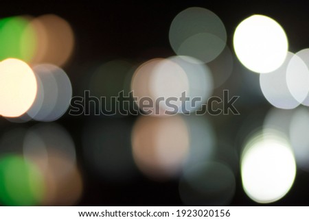 A black background with a large bokeh of light spread across the entire image.