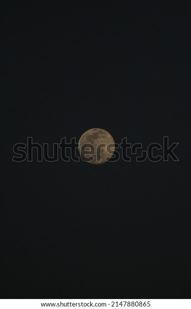 Black\
background and in the middle there is a full\
moon